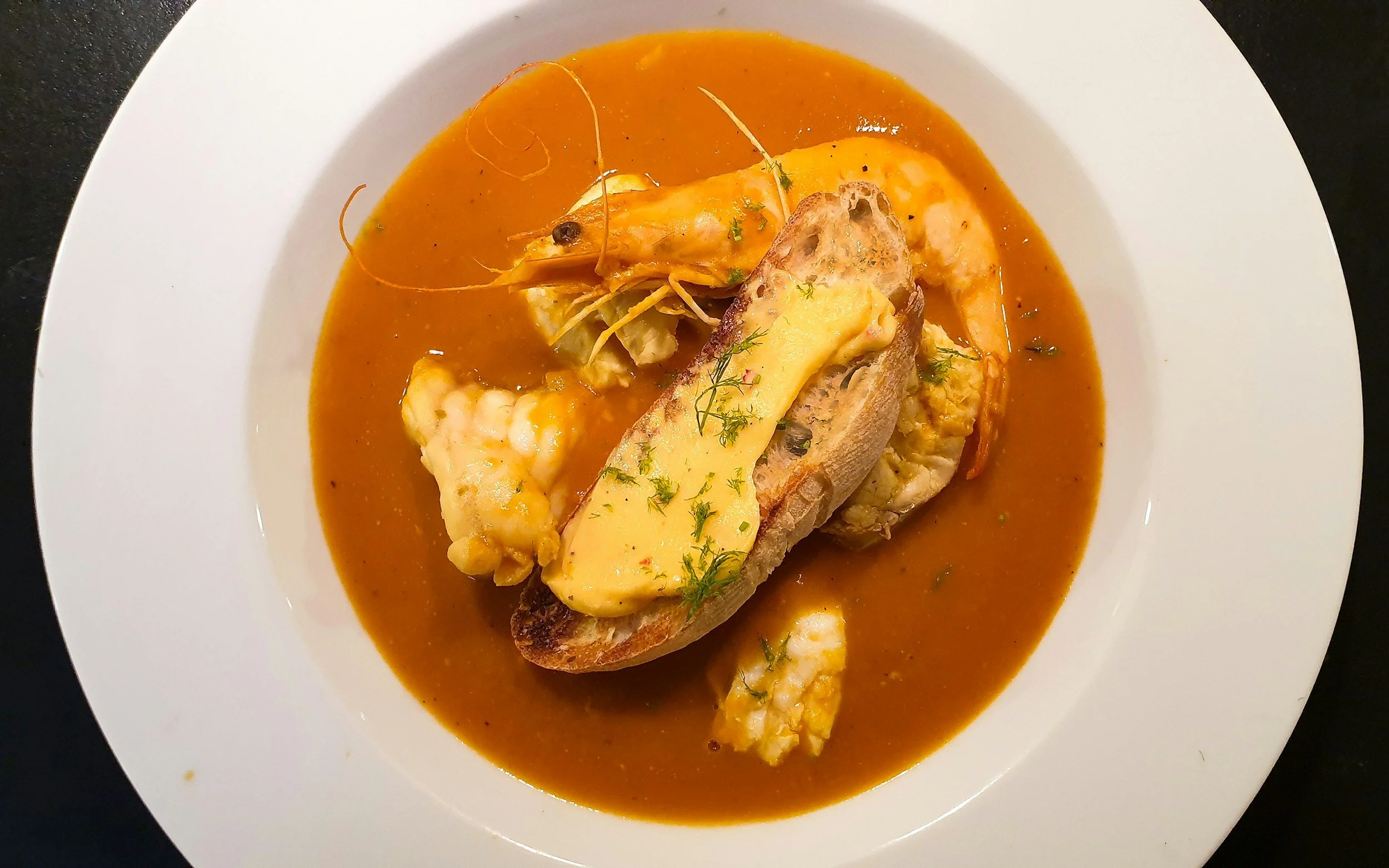  Traditional bouillabaisse is sered with a slice of toasted bread slathered in rouille  