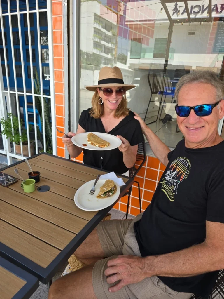 Sitting at a wooden table in Puerto Vallarta on a food tour
