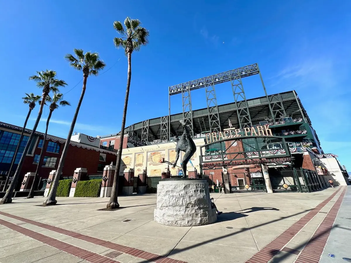 Oracle Park entrance with  palm trees and statue