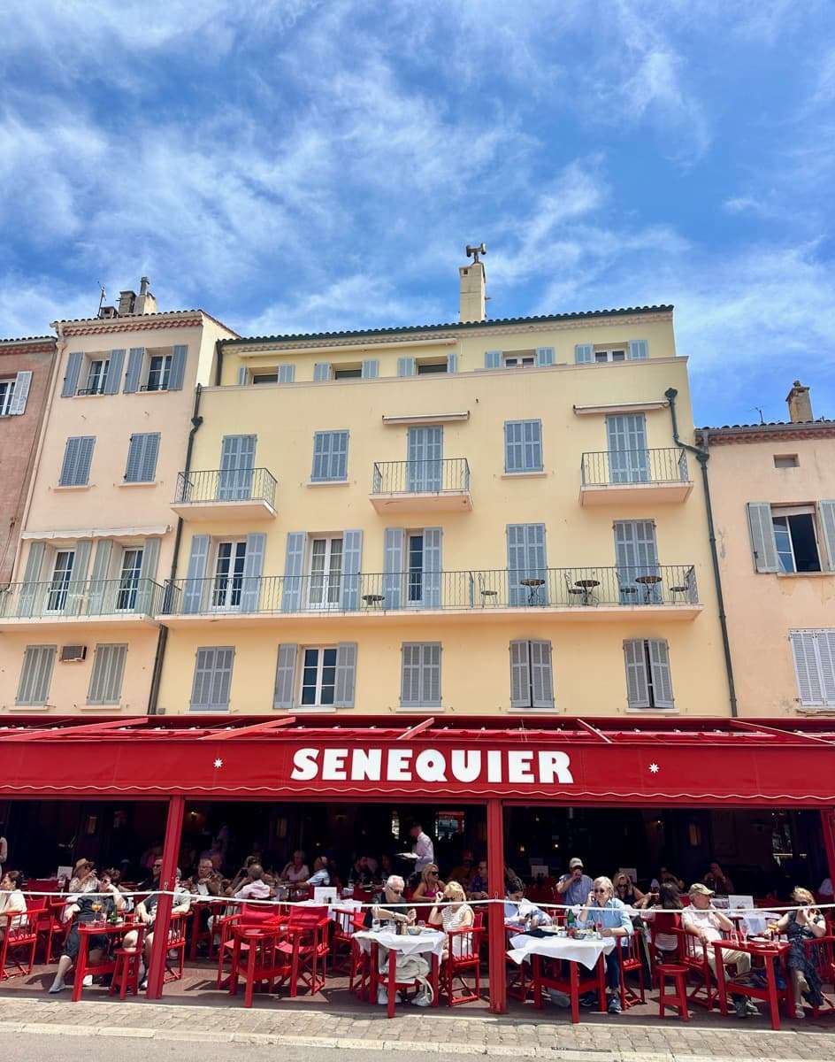 Le senquier cafe in saint tropez and its red awning on the port