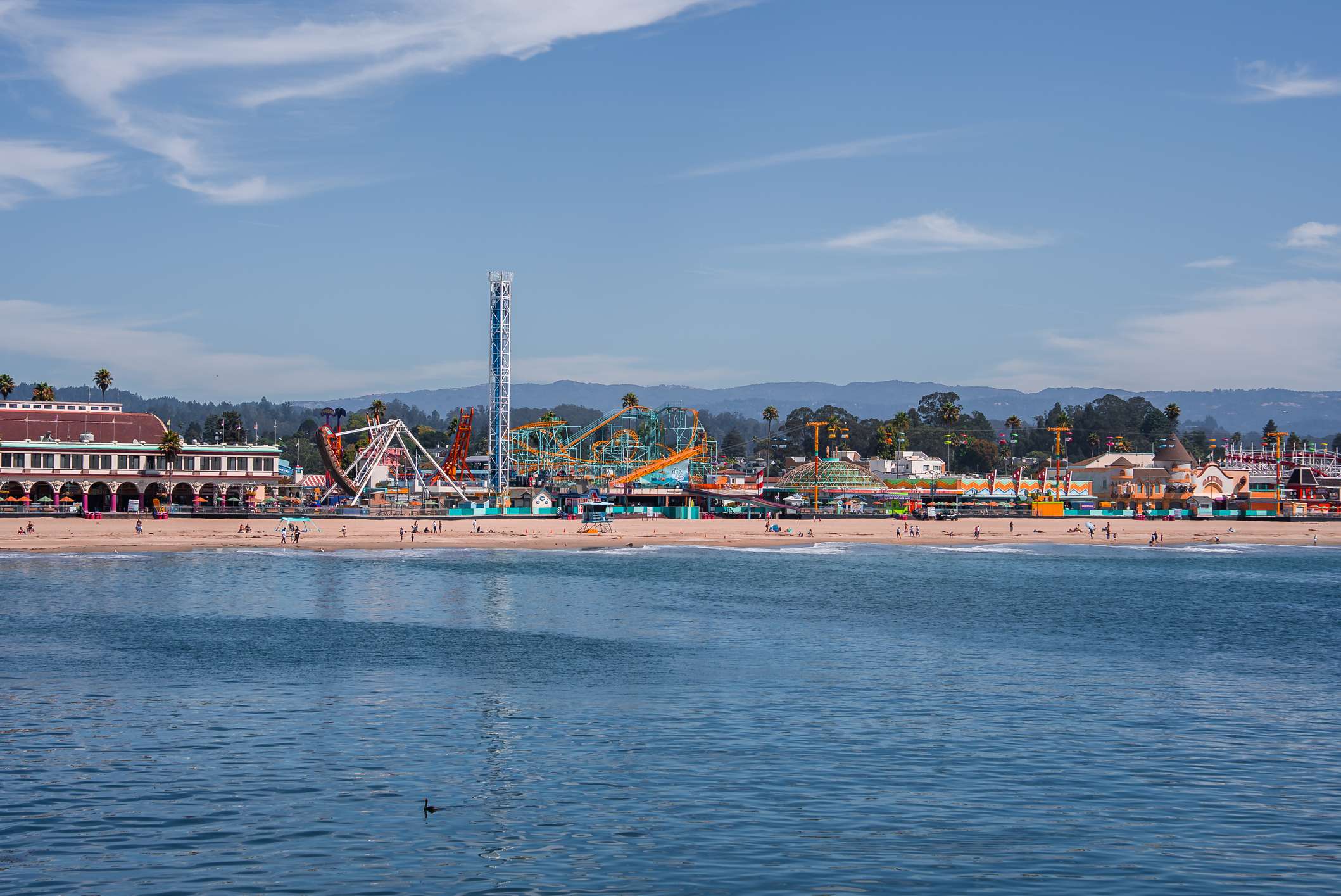 The Santa Cruz Beach Boardwalk as seen from the ocean, with views of the rides and arcades