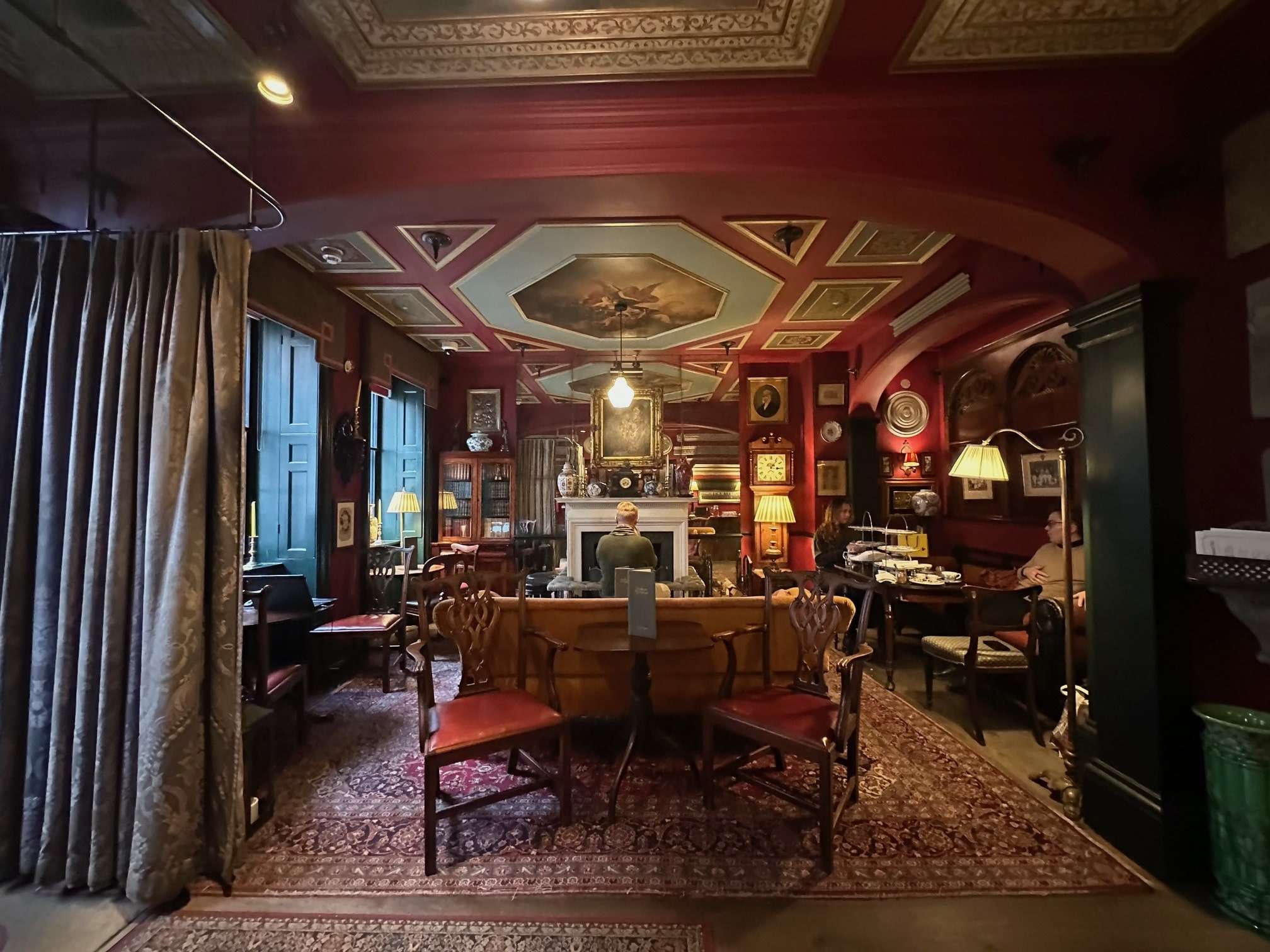 The parlour inside the Zetta with art filled walls and antique furniture