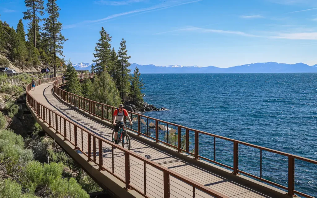 a bike rider on the east shore trail of lake tahoe