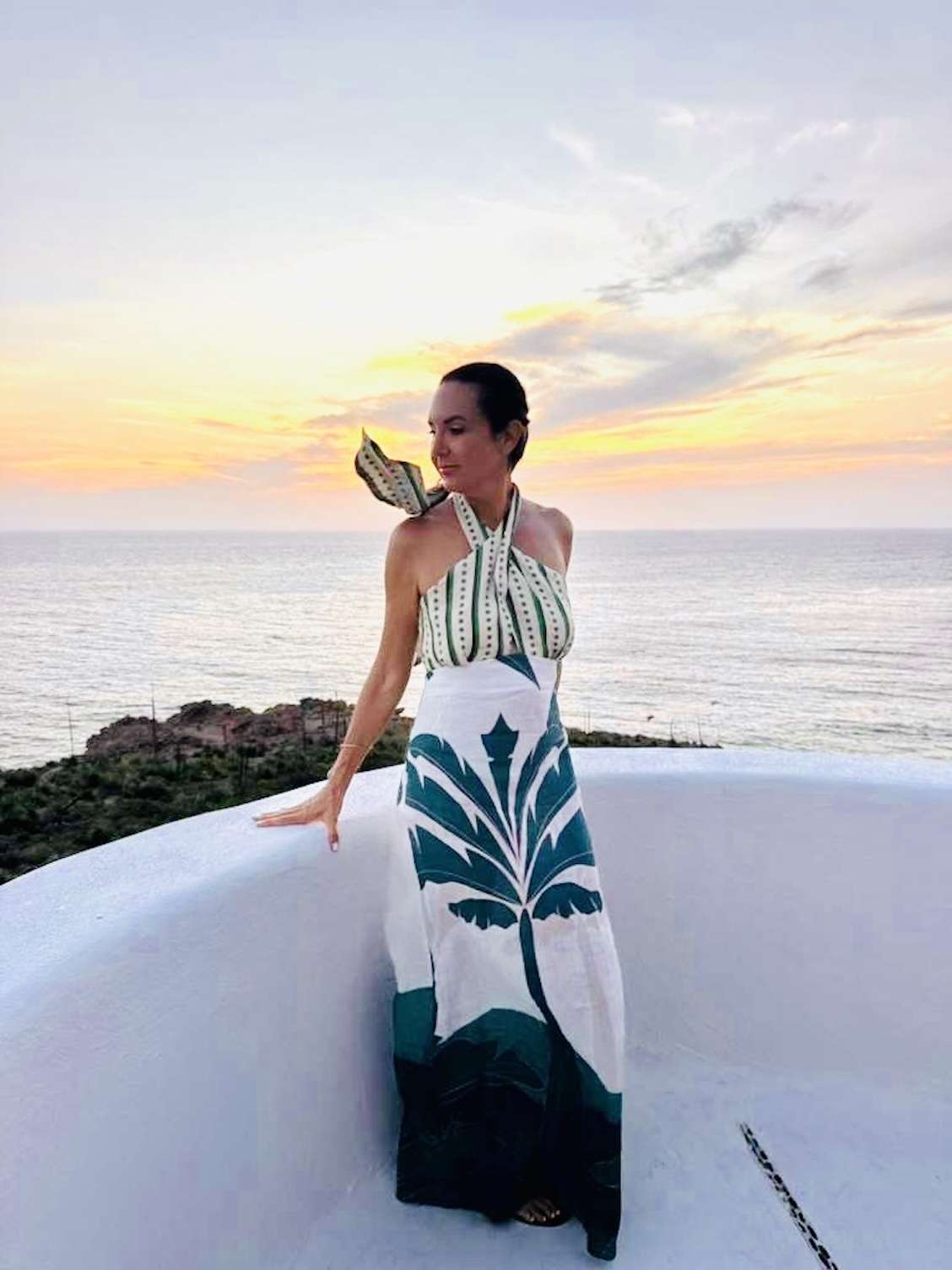 fashionable woman in green and white dress in careyes, mexico