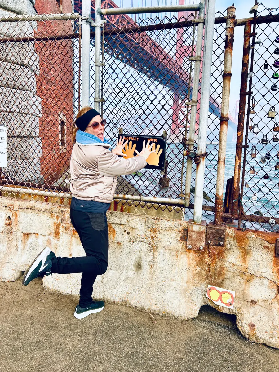 woman at hoppers hands on crissy field with the golden gate bridge in the background