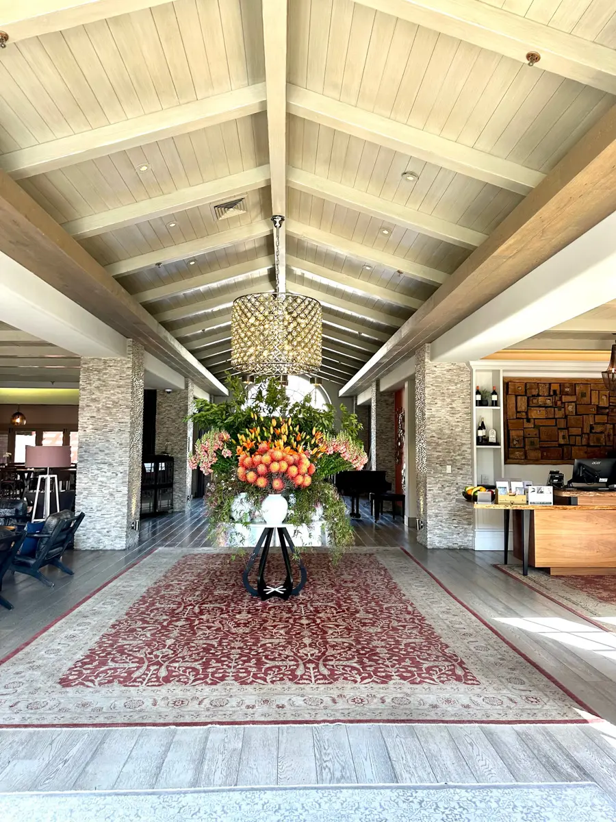lobby at  bernardus lodge & spa with fresh flowers on a table