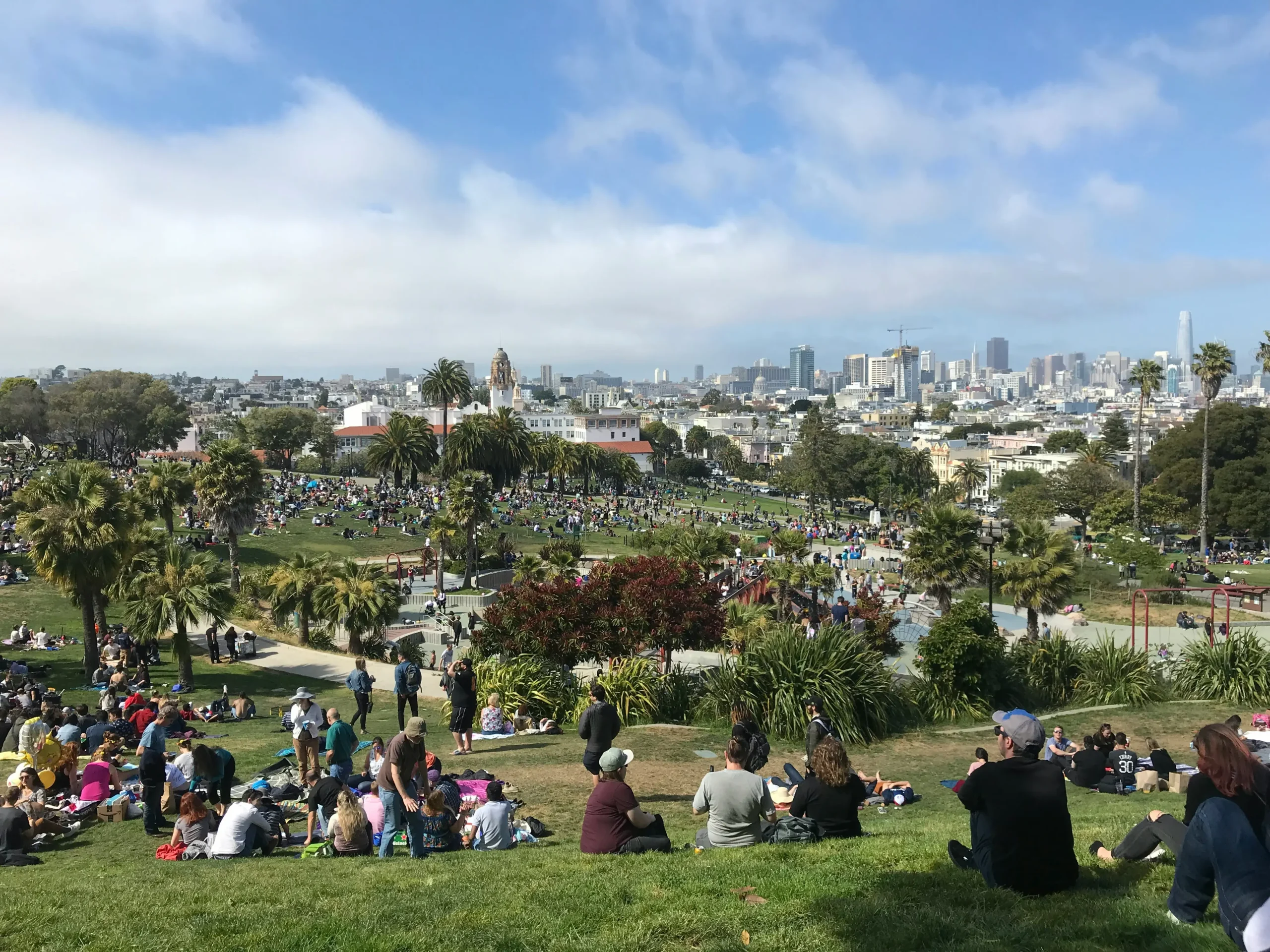 people enjoying the sun in dolores park in san francisco, a popular place in the fall when the weather is warm 