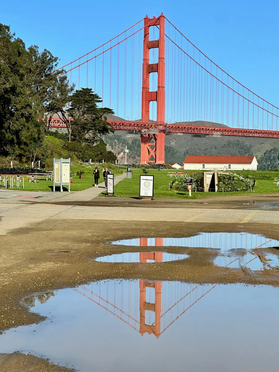 san francisco golden gate bridge with reflection in puddle after the rain