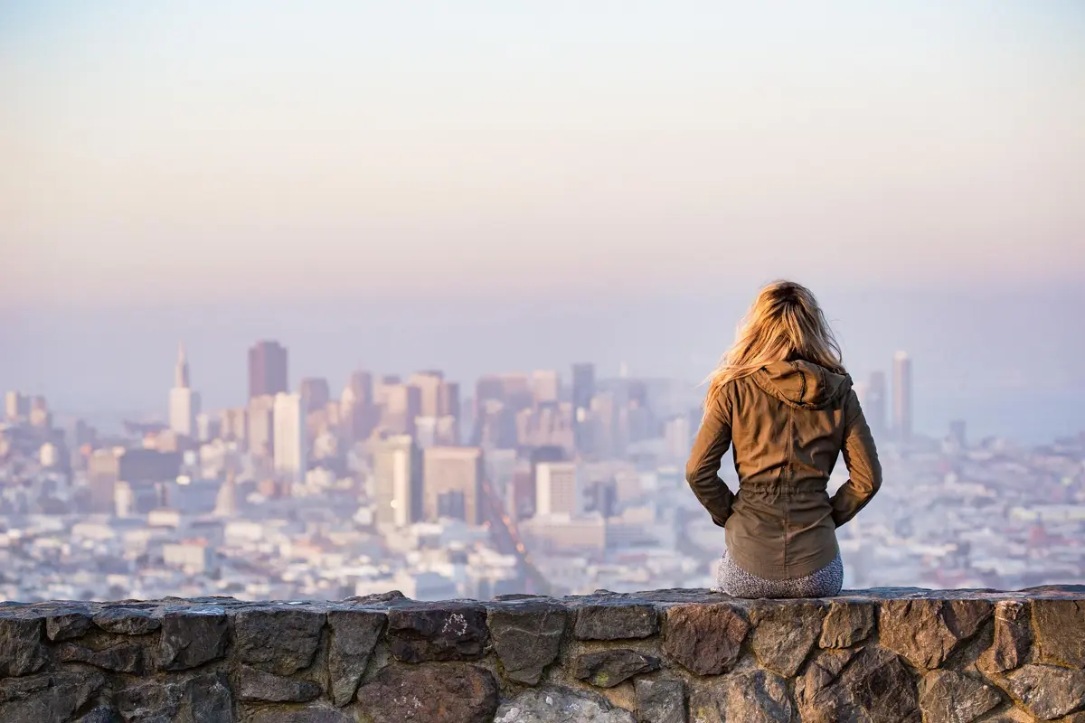 woman overlooking san francisco city skyline from park