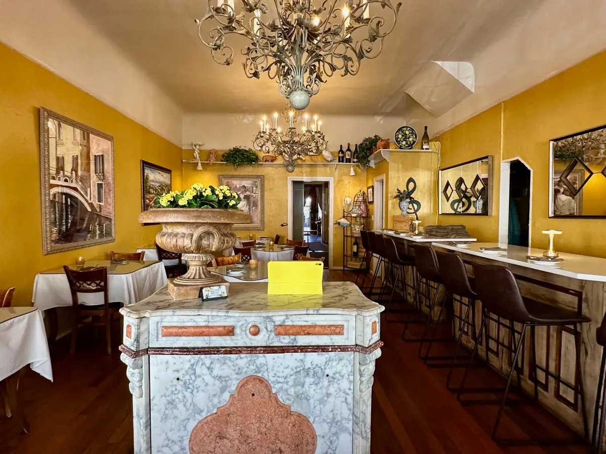 magic flute restaurant interior with yellow walls and photos of italy