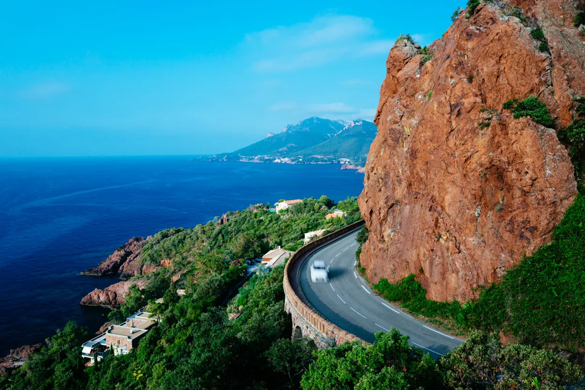 car on a cliffside road in the french riviera