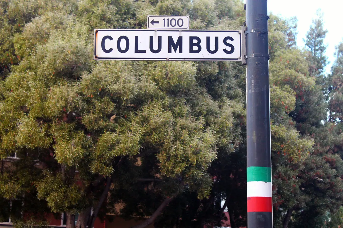 columbus street in san francisco with italian flag painted on pole