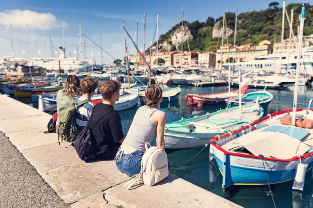 backs of family looking at boats on the french riviera