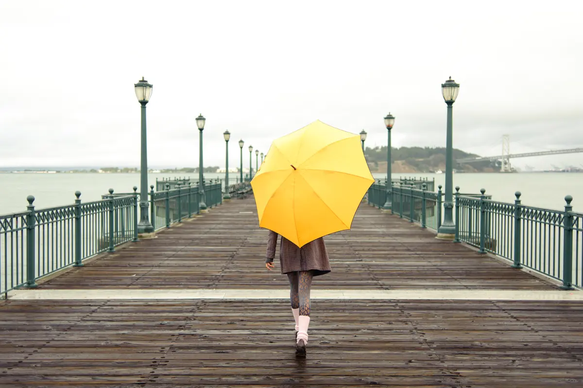 girl with yellow umbrella walking on pier 7
in san francisco