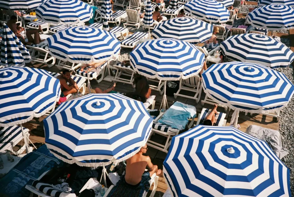french riviera blue and white striped beach umbrellas