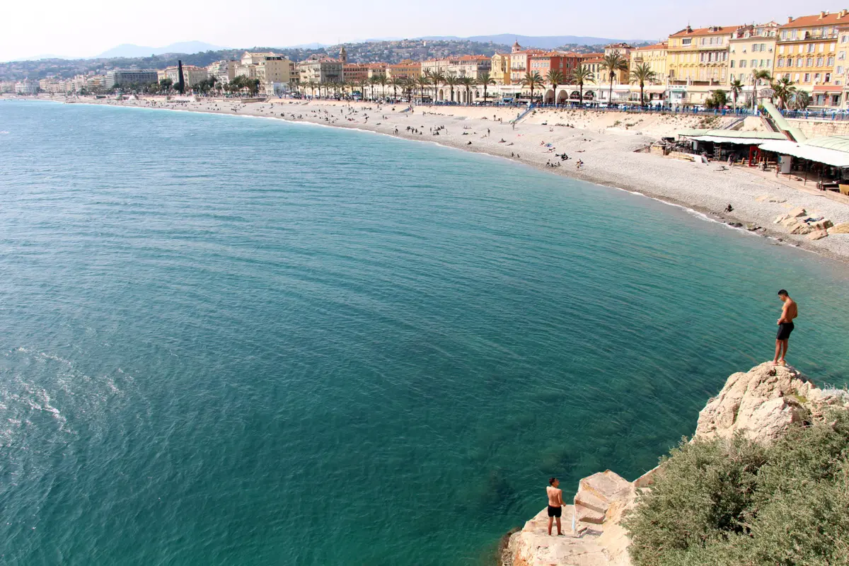 man on rocky cliff about to jump in Nice, France, 