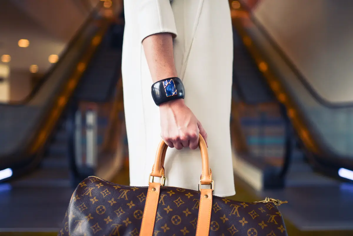 shopping in monaco with a louis vuitton bag