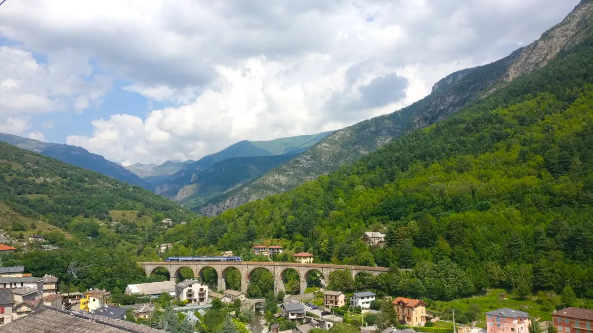train des merveilles traveling over arched bridge in roya valley