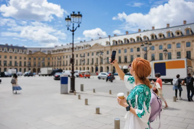 Woman taking a photo with her phone on the French Riviera