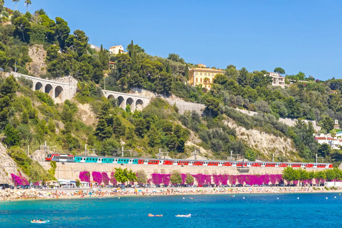 TER coastal train runs past Villefranche-sur-mer plage des Marinières