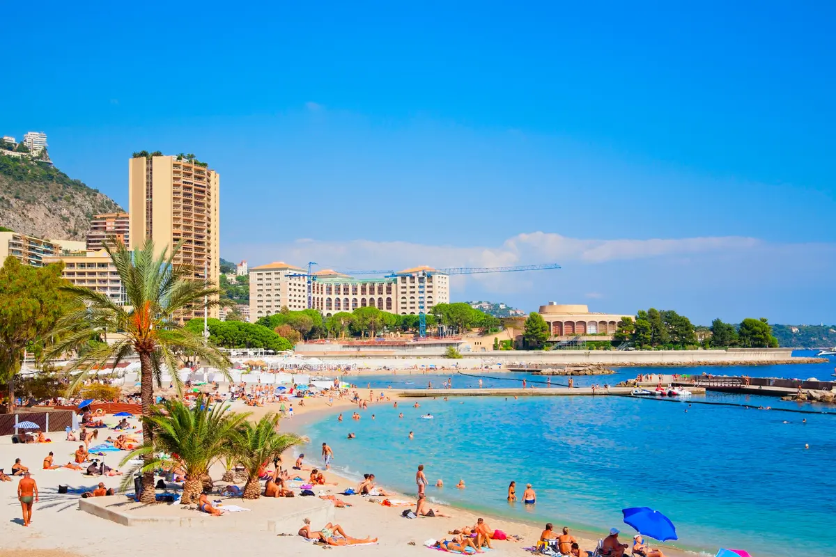 larvotto beach in monaco with umbrellas and blue water