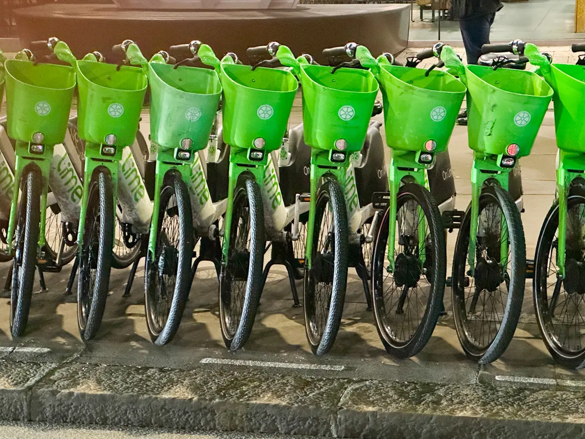 lime bikes lined up on the street