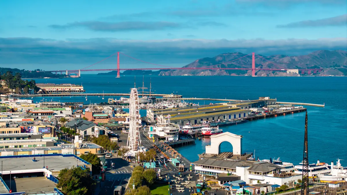 fisherman's wharf san francisco with view of ferris wheel and golden gate bridge