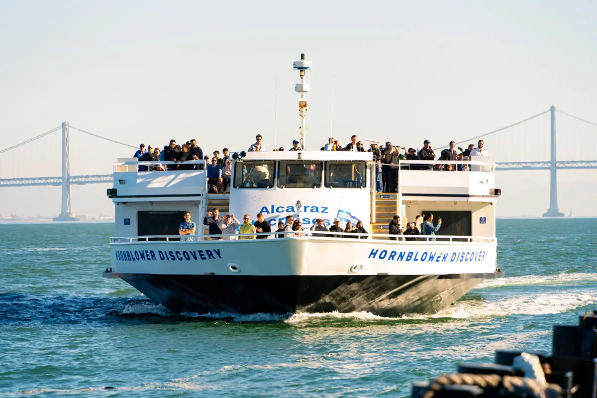 alcatraz city cruises boat with bay bridge in background