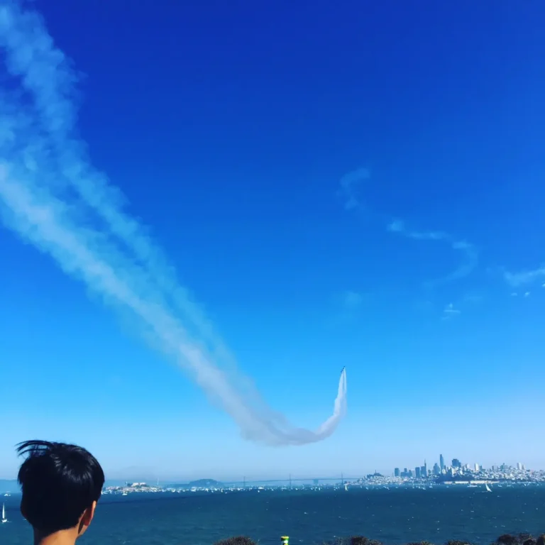 airplane trail above the san francisco bay during fleet week