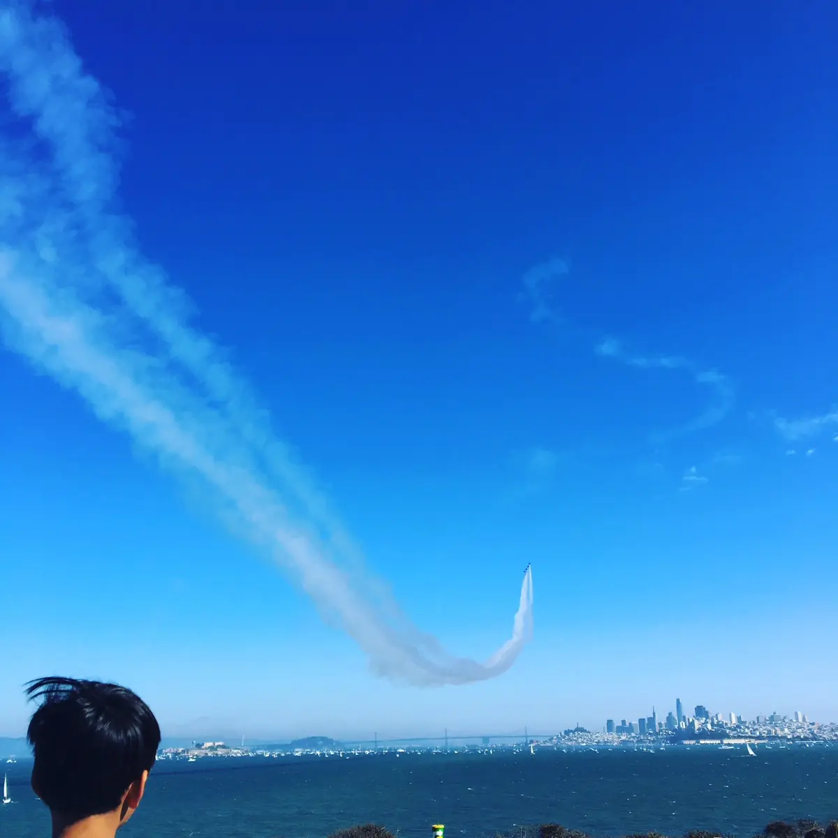 airplane trail above the san francisco bay during fleet week