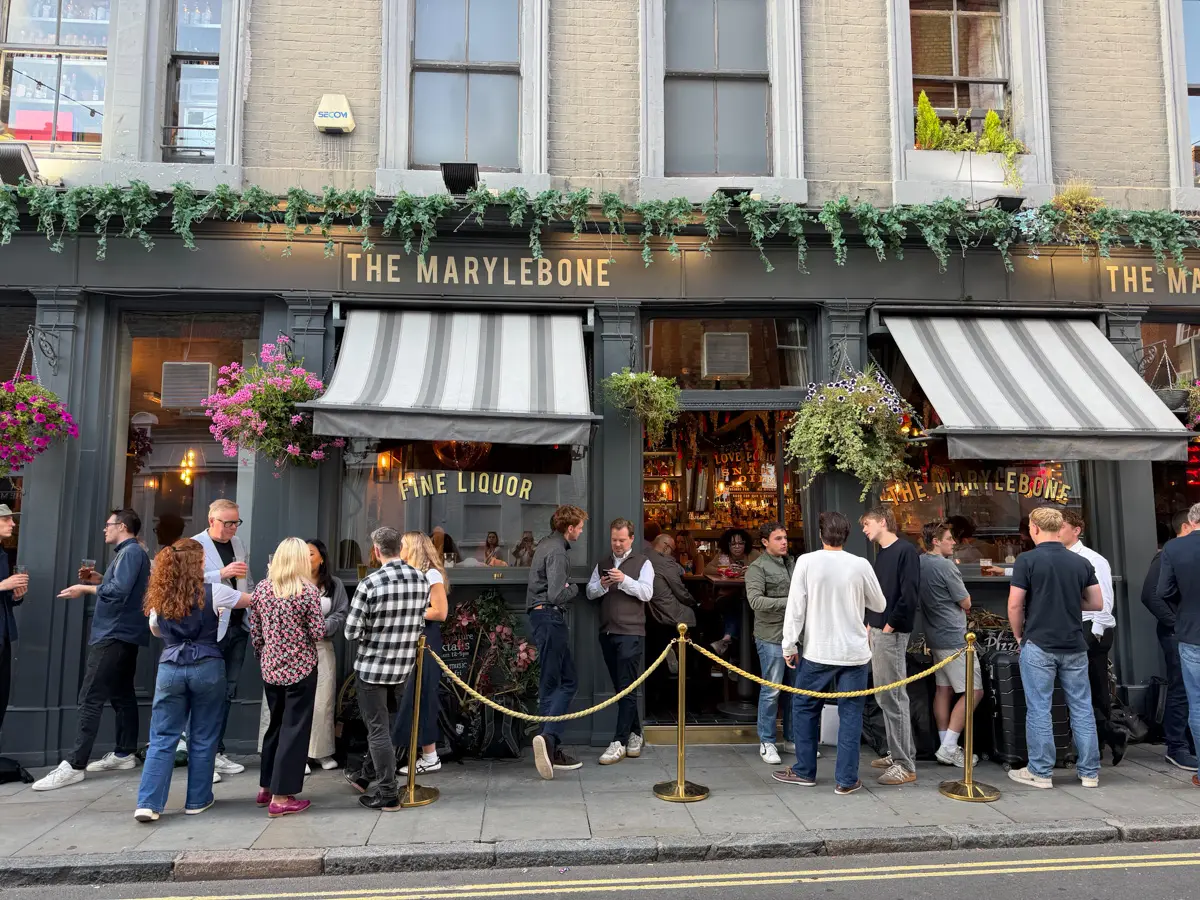 Marylebone pub in london with people standing outside