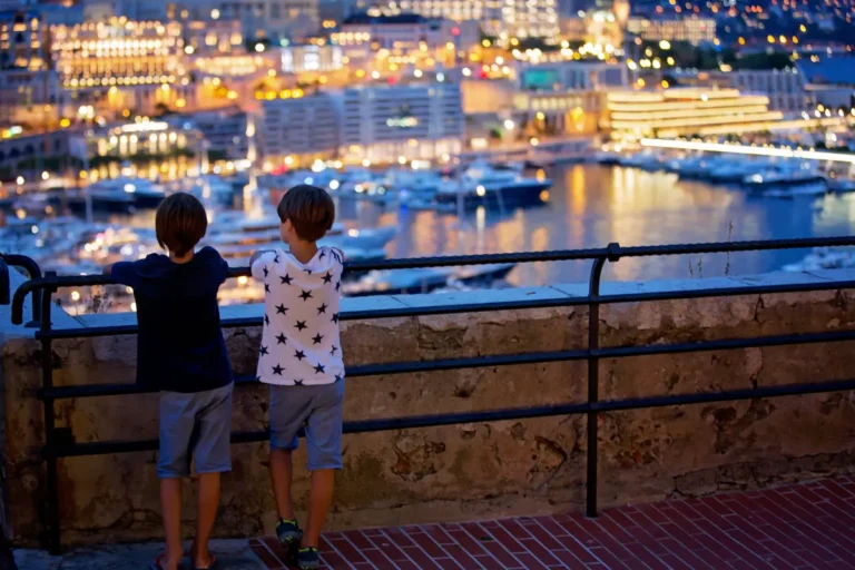 two kids looking at monaco yacht harbor